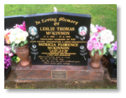 Tall Black Headstone on Multi-Coloured Red Base and Two Vases