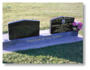 Two Black Apex Headstones on Harcourt Base with Two Flower Inserts